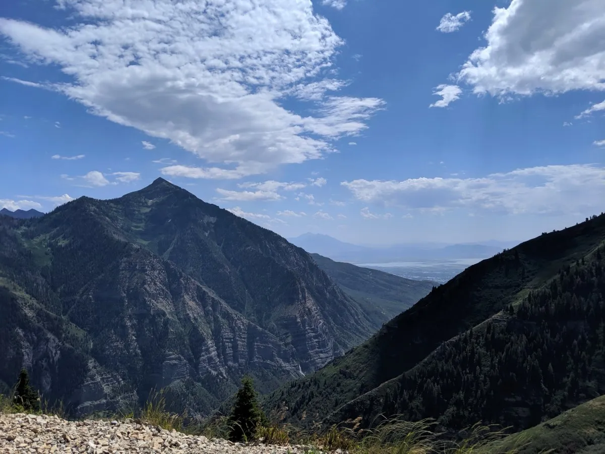 Steep mountain peak above a hazy valley